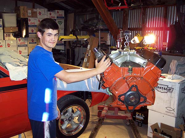 Chrysler 440 hanging from engine hoist.